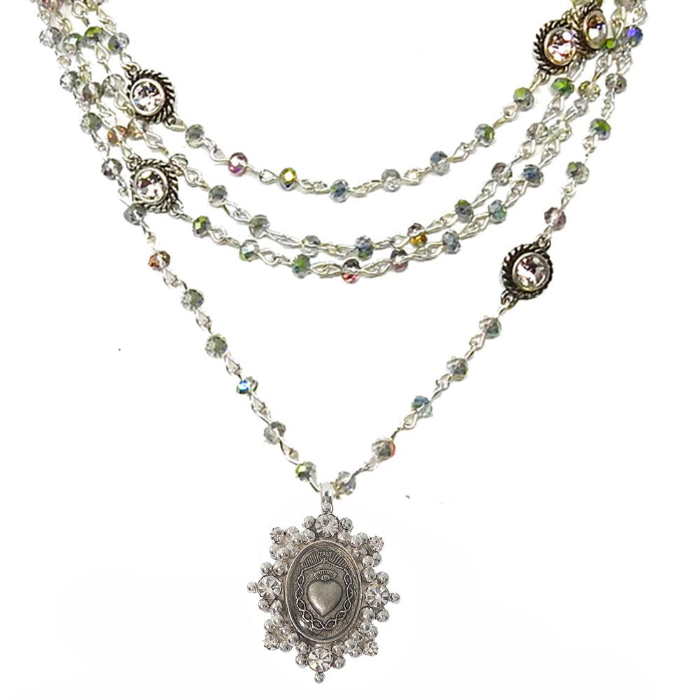 Layered silver necklace with iridescent crystal beads and ornate pendant featuring a sacred heart charm.