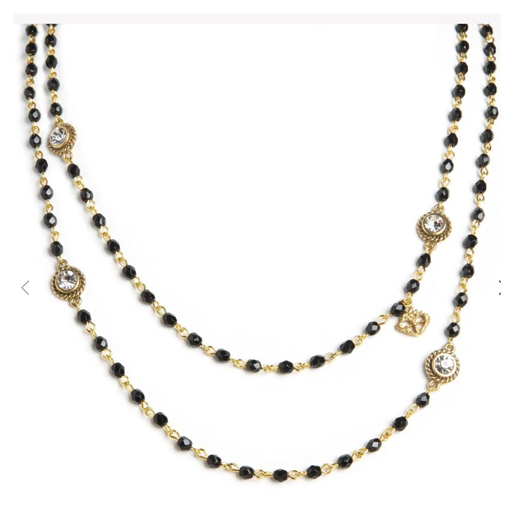 Double-strand black beaded necklace with gold accents and clear crystal details.