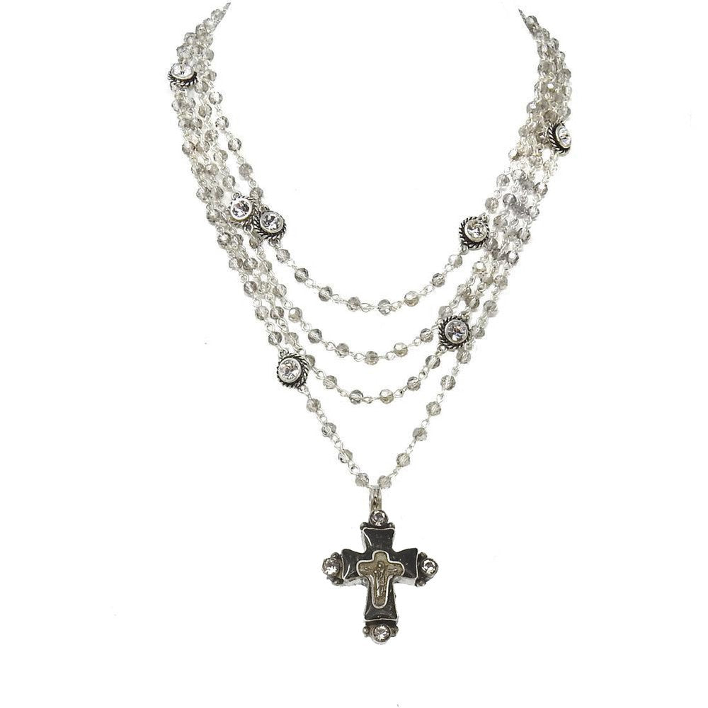 Layered crystal bead necklace with ornate cross pendant.