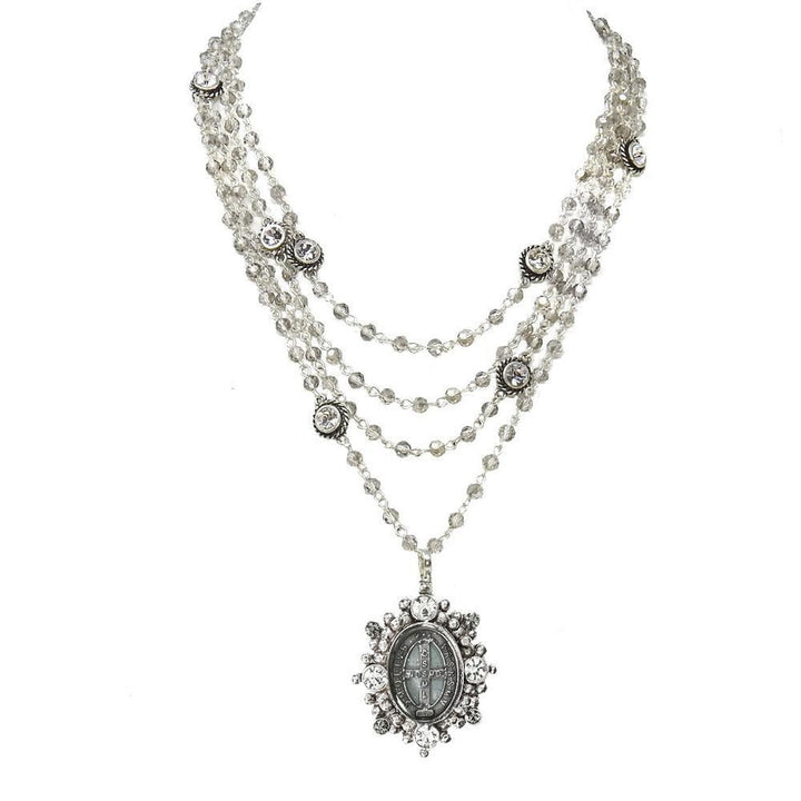 Multi-strand crystal beaded necklace with a silver medallion pendant.