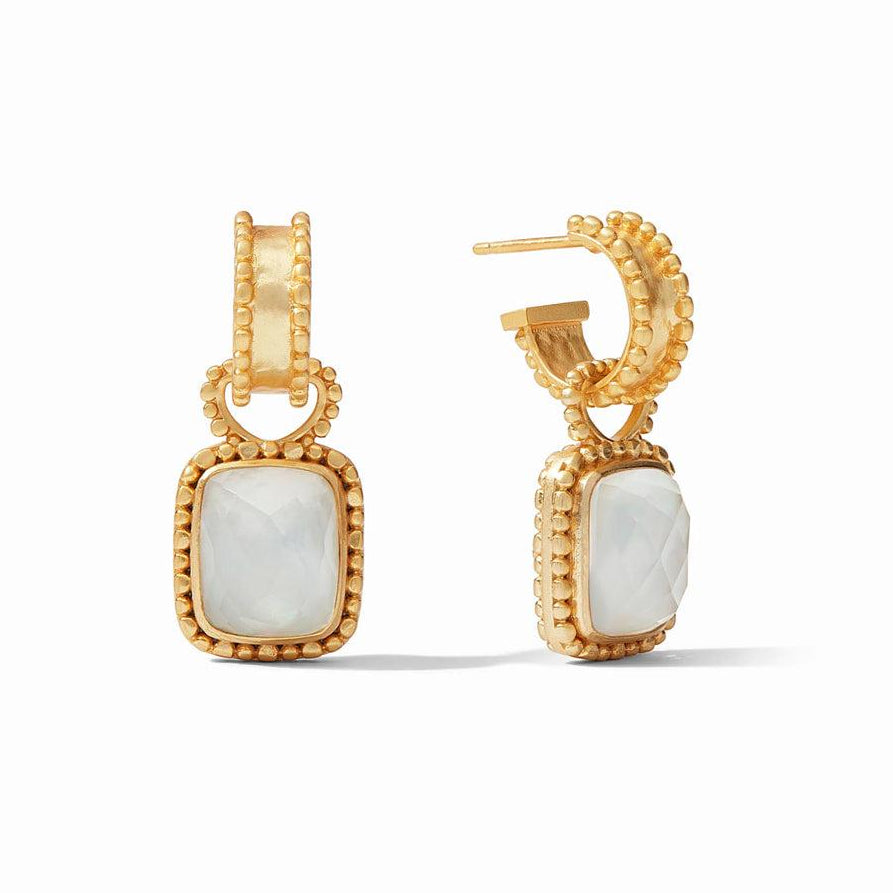 Gold hoop earrings with a dangling white gemstone, detailed close-up.
