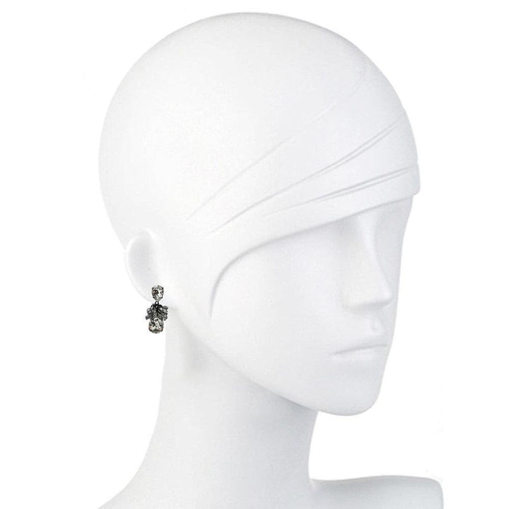 Elegant dark gray crystal earrings on a white mannequin.