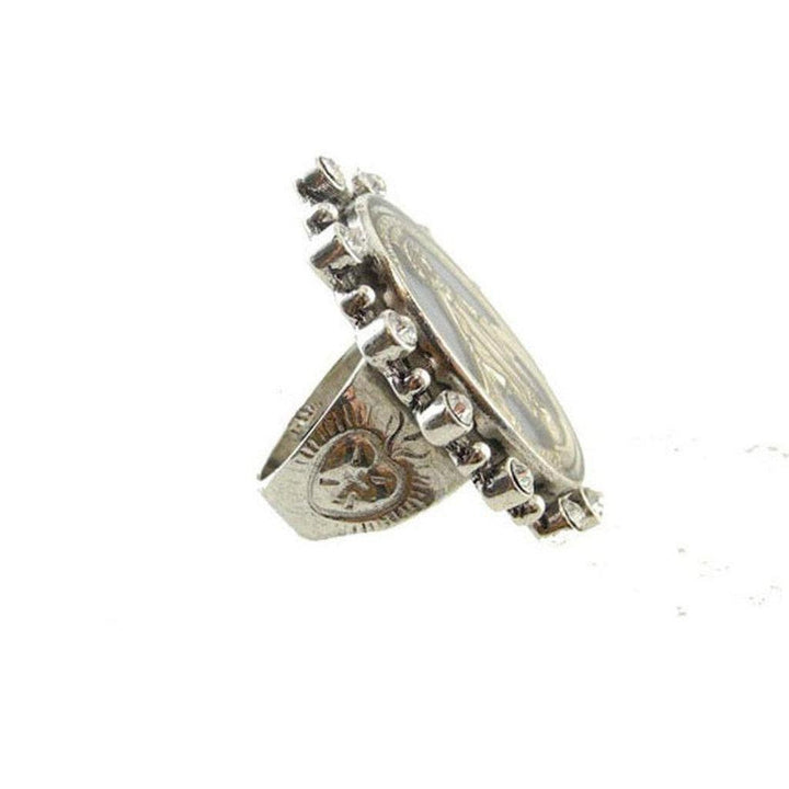 Silver ring featuring a religious medallion, adorned with clear crystals, size 9.