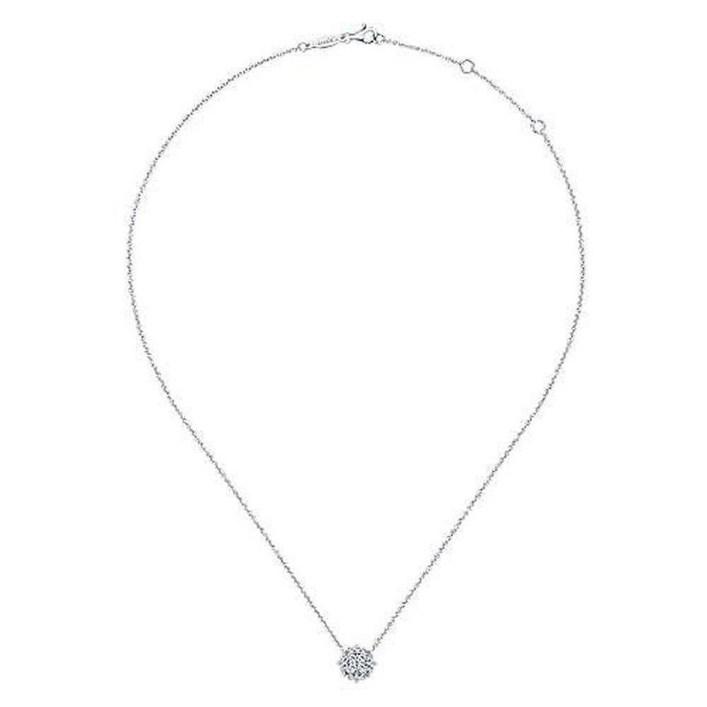 Dainty diamond pendant necklace with a cluster setting on a delicate chain.
