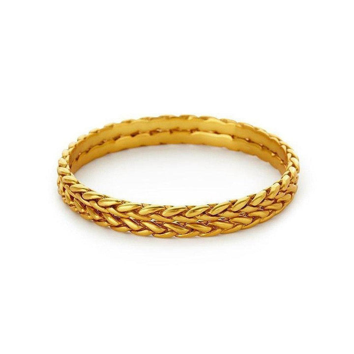 Gold bangle bracelet with braided design, shown on a white background.