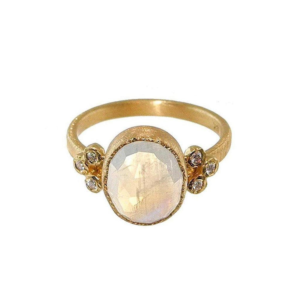 Oval moonstone ring in 18k gold with delicate diamond accents.