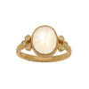 Oval moonstone ring in 18k gold with diamond accents.