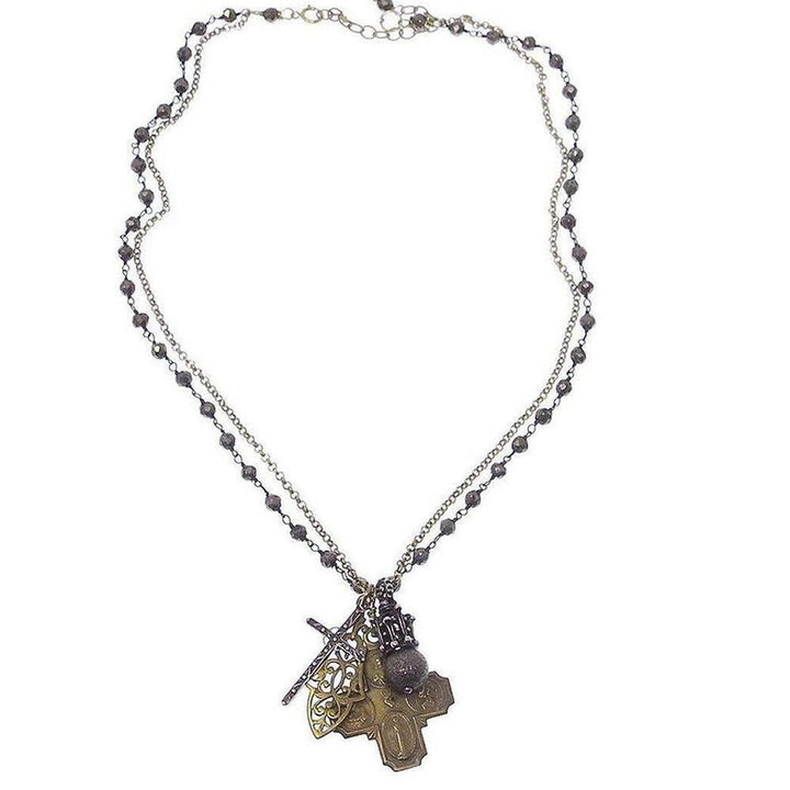 Double-chain necklace featuring multiple antique-style cross pendants and beaded accents.
