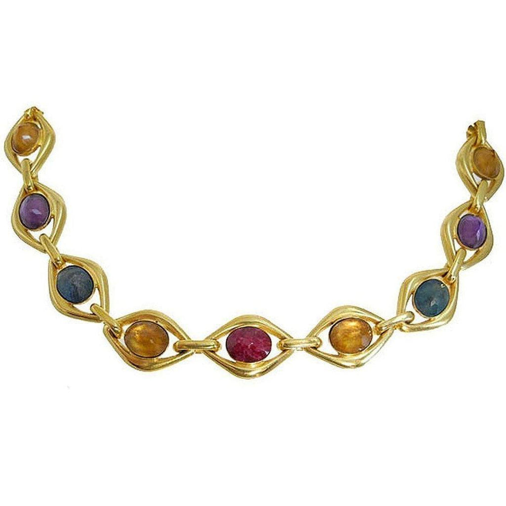 Gold link necklace featuring multicolored cabochon stones.