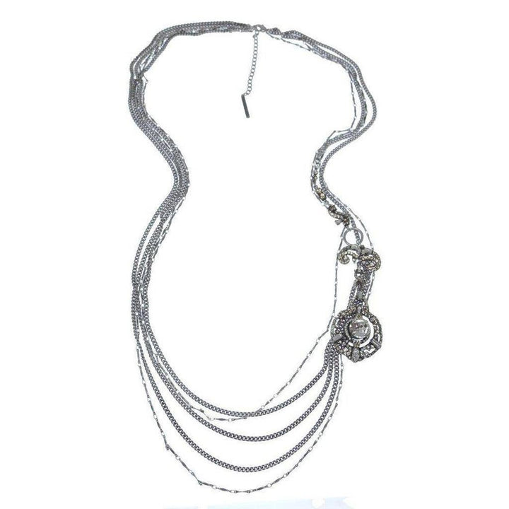 Multi-strand silver necklace with a long, ornate pendant featuring a cabochon stone.