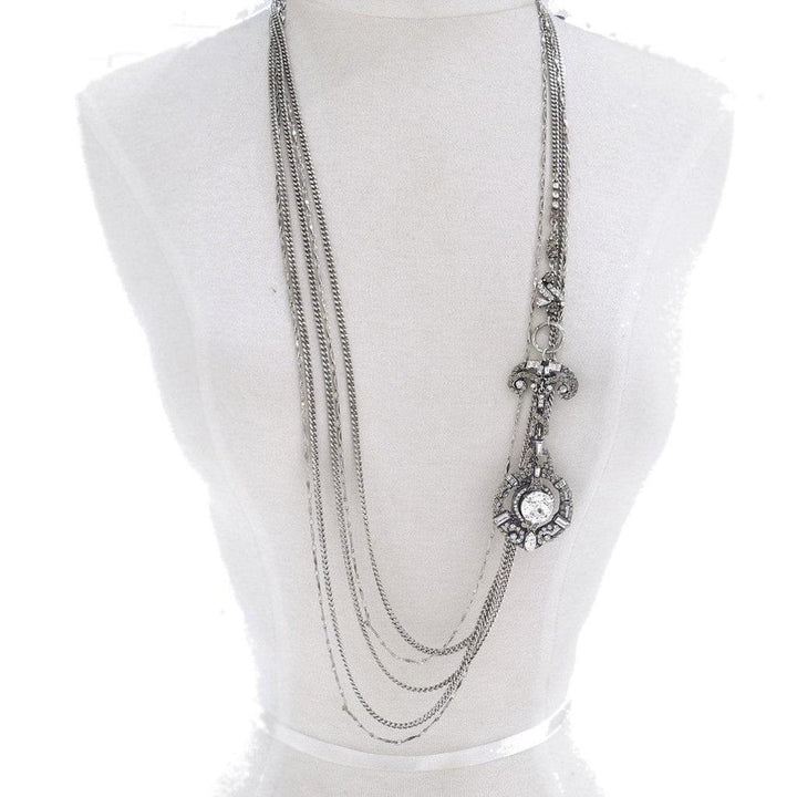 Silver multi-strand necklace with long, dangling cabochon pendant.