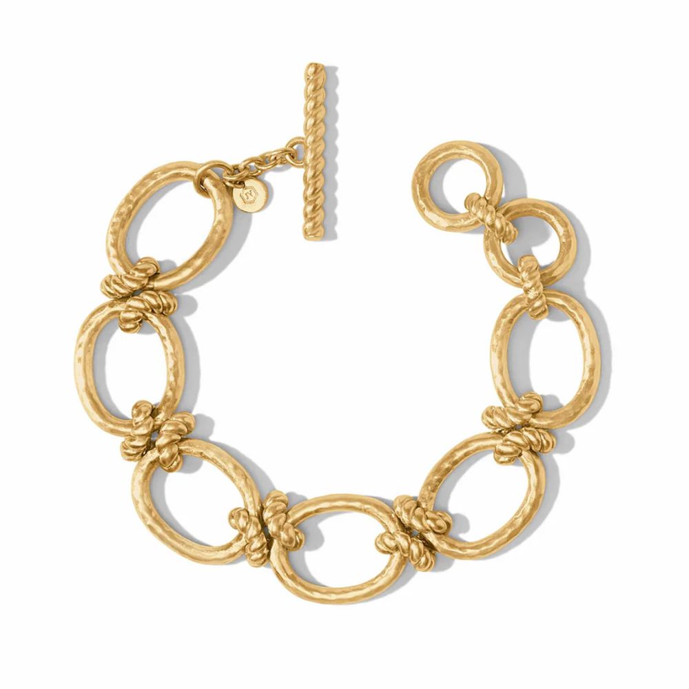 Gold hammered-metal link bracelet with twisted detailing and toggle clasp.