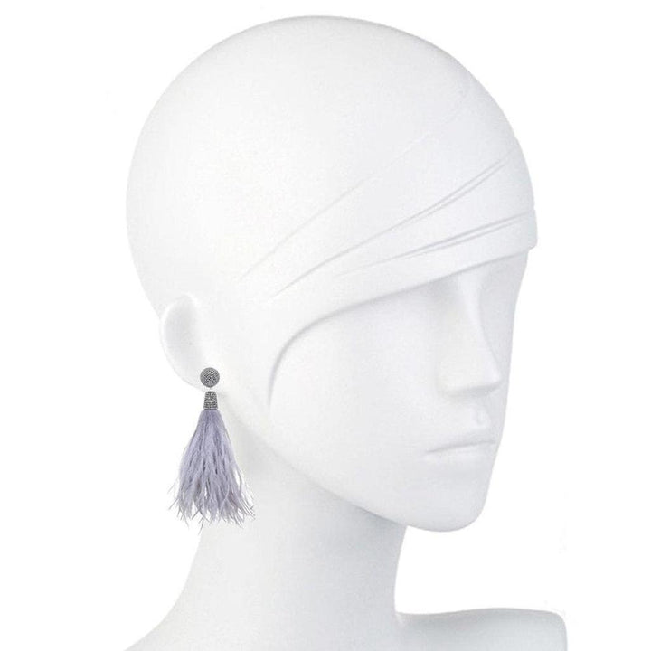 Lavender feather earrings with beaded accents, displayed on a mannequin.