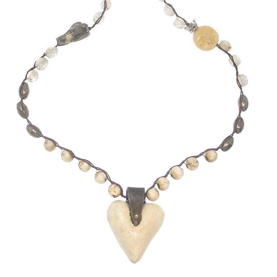 Artisan heart necklace with off-white heart pendant, brown cord, and beige beads.