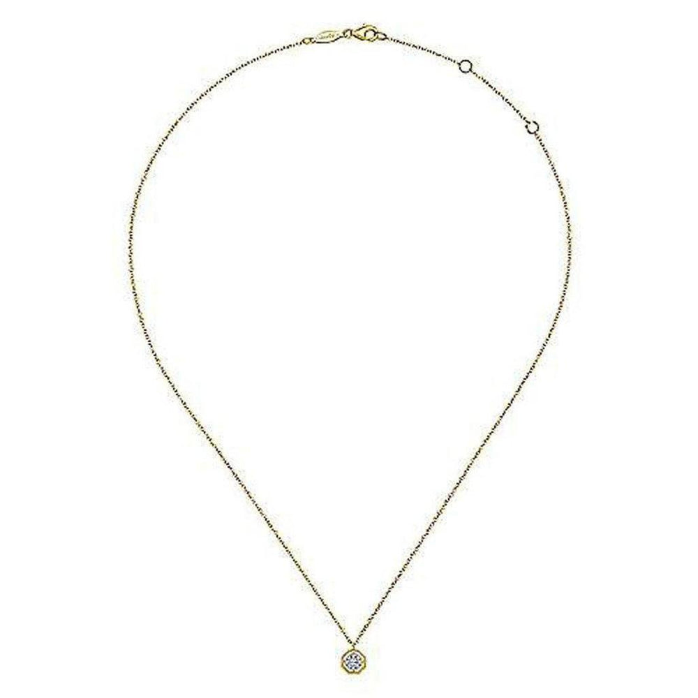 Dainty gold chain necklace featuring a small octagonal diamond pendant.
