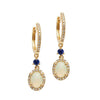 Opal Huggie Earrings with Blue Sapphires: 14k gold huggie hoops, oval opal & sapphire accents.