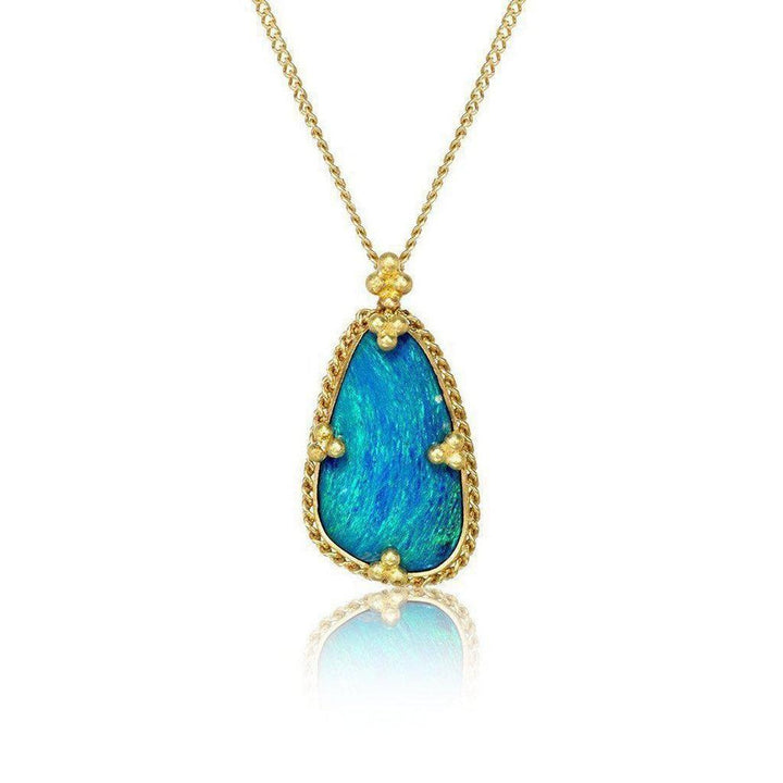 Teardrop opal pendant, gold setting, on white background