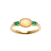 Gold opal and emerald ring with delicate detailing.
