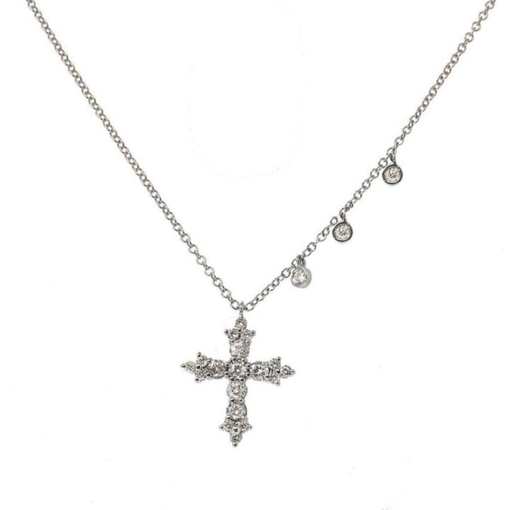 Diamond cross pendant necklace with three bezel accents on delicate chain.