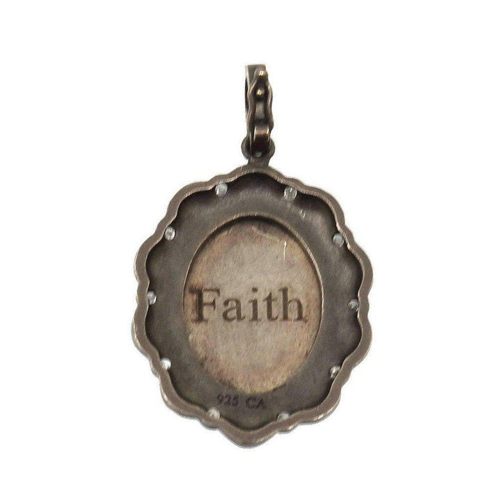 Silver pendant featuring diamond accents and the word "Faith."