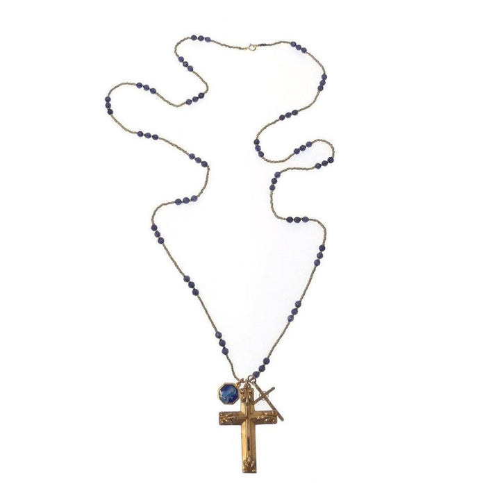 Gold cross necklace with dark blue beads; features a smaller cross charm.