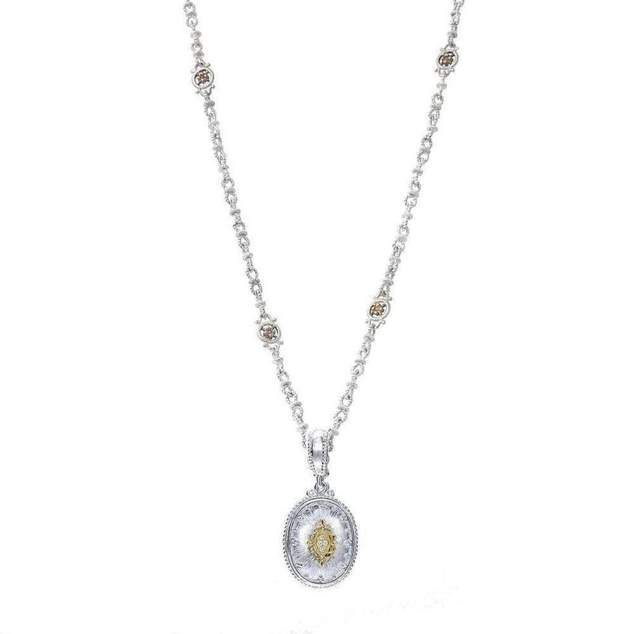 Oval diamond pendant necklace with ornate silver chain and accents.