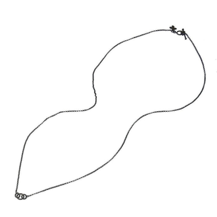 Dark oxidized silver chain necklace featuring three interlocking rings.
