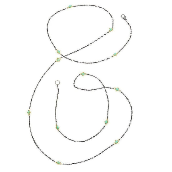 Long oxidized silver chain necklace with turquoise and gold accents.