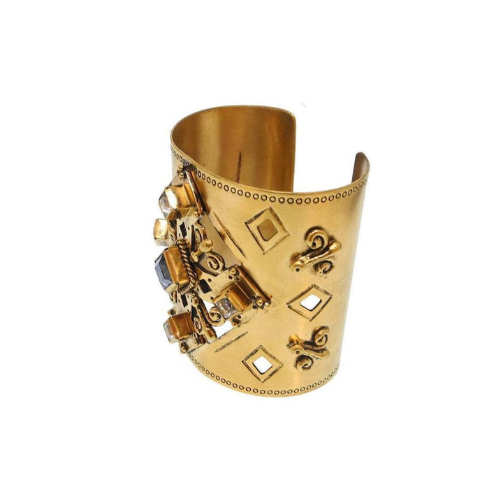 Gold cuff bracelet with ornate detailing and gemstone accents.