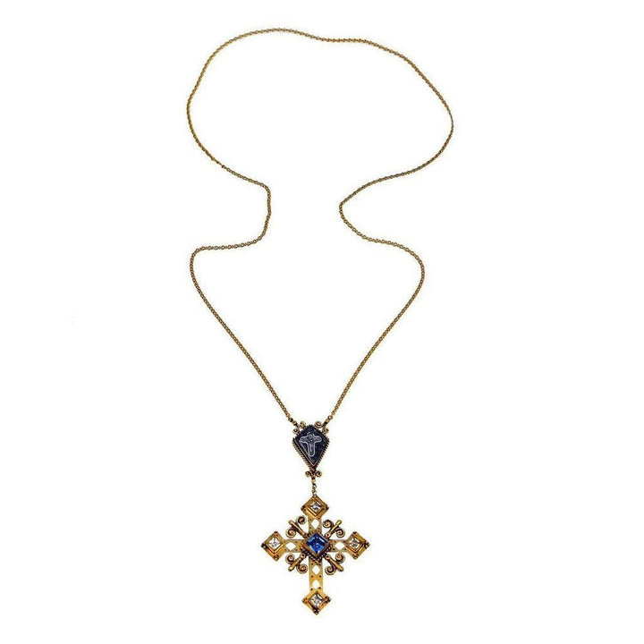 Gold chain necklace with ornate cross pendant featuring blue and clear stones.