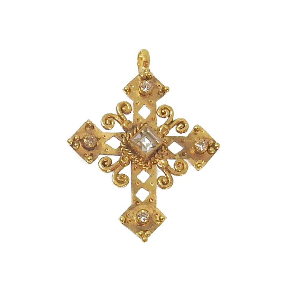 Gold Paloma cross medallion pendant with clear center stone and small diamonds.