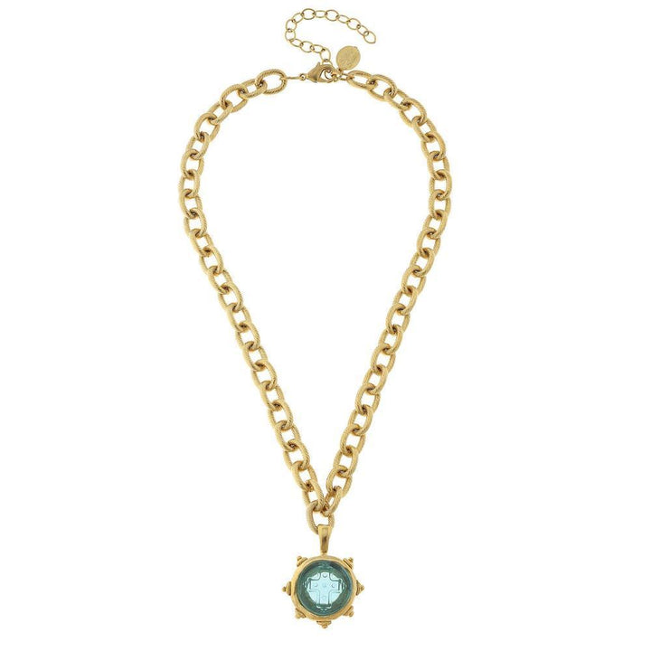 Gold chain necklace featuring a light blue Venetian glass cross pendant.