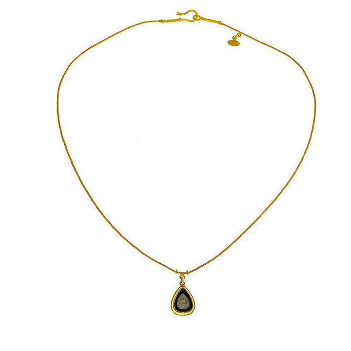 Elegant gold chain necklace featuring a teardrop pendant with a dark gray stone.