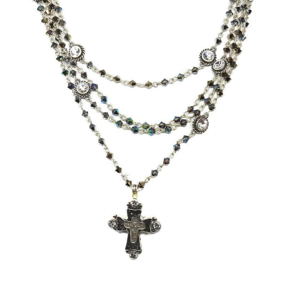 Metallic blue Bicone Magdalena necklace: layered crystal & cross pendant.