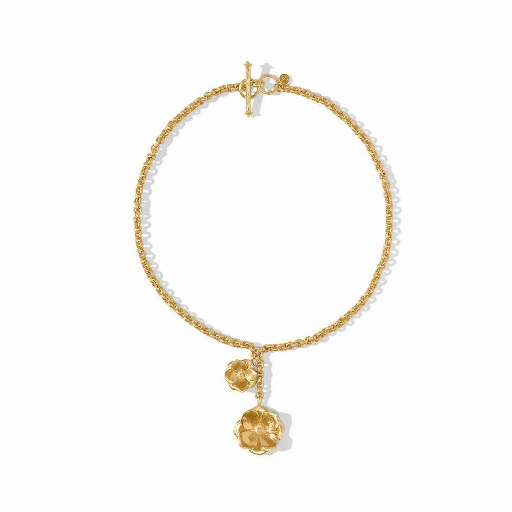 Gold lariat necklace with textured chain and floral charms.