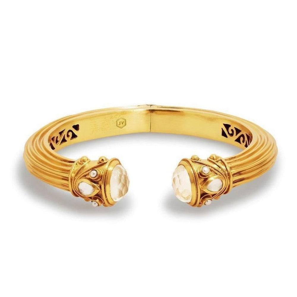 Gold cuff bracelet featuring clear stones and ornate detailing.