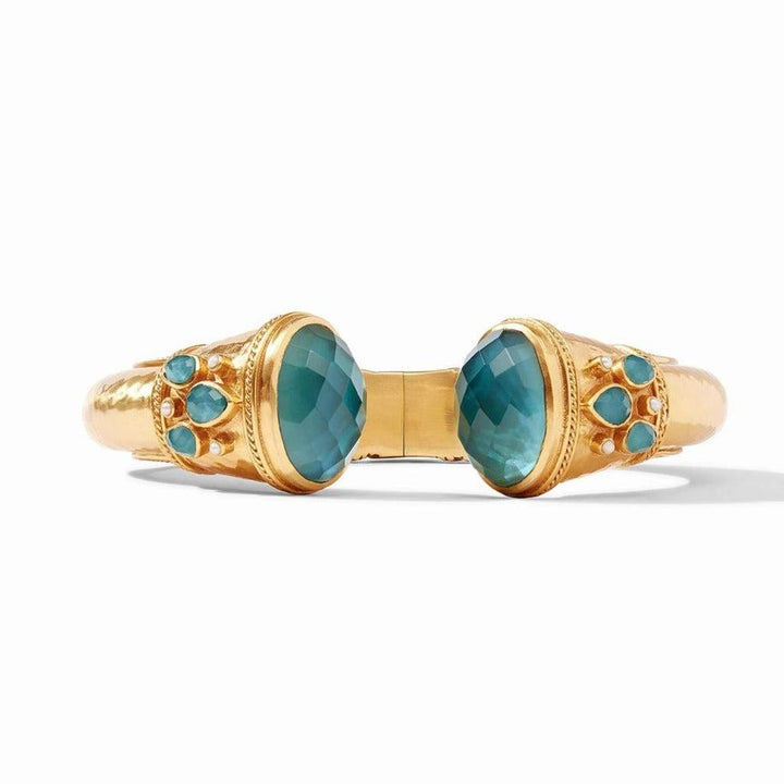 Gold hinged cuff bracelet featuring teal gemstones and textured detailing.