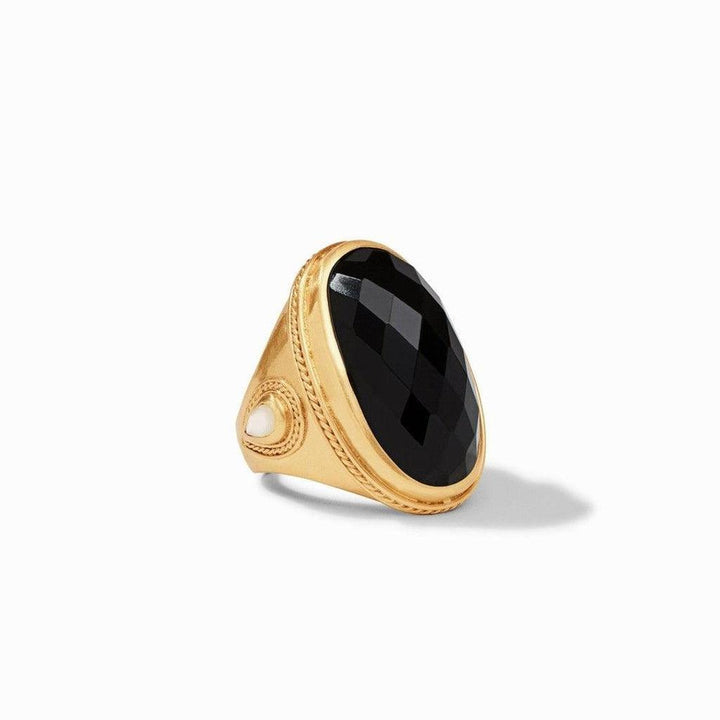 Gold statement ring featuring a large black onyx stone and small white accent.