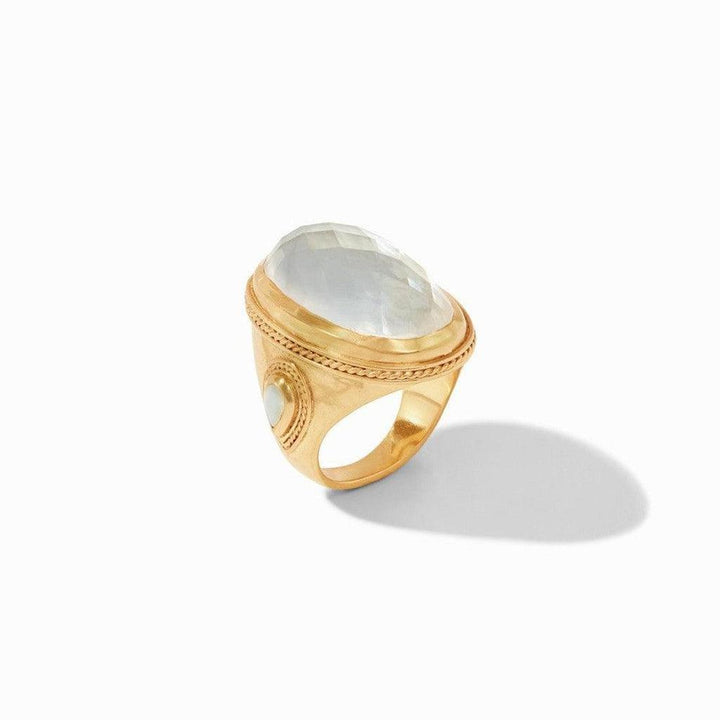 Gold statement ring featuring a large oval gemstone and detailed accents.