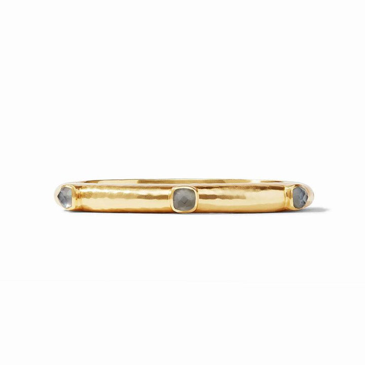 Gold hinged bangle with gray gemstones.