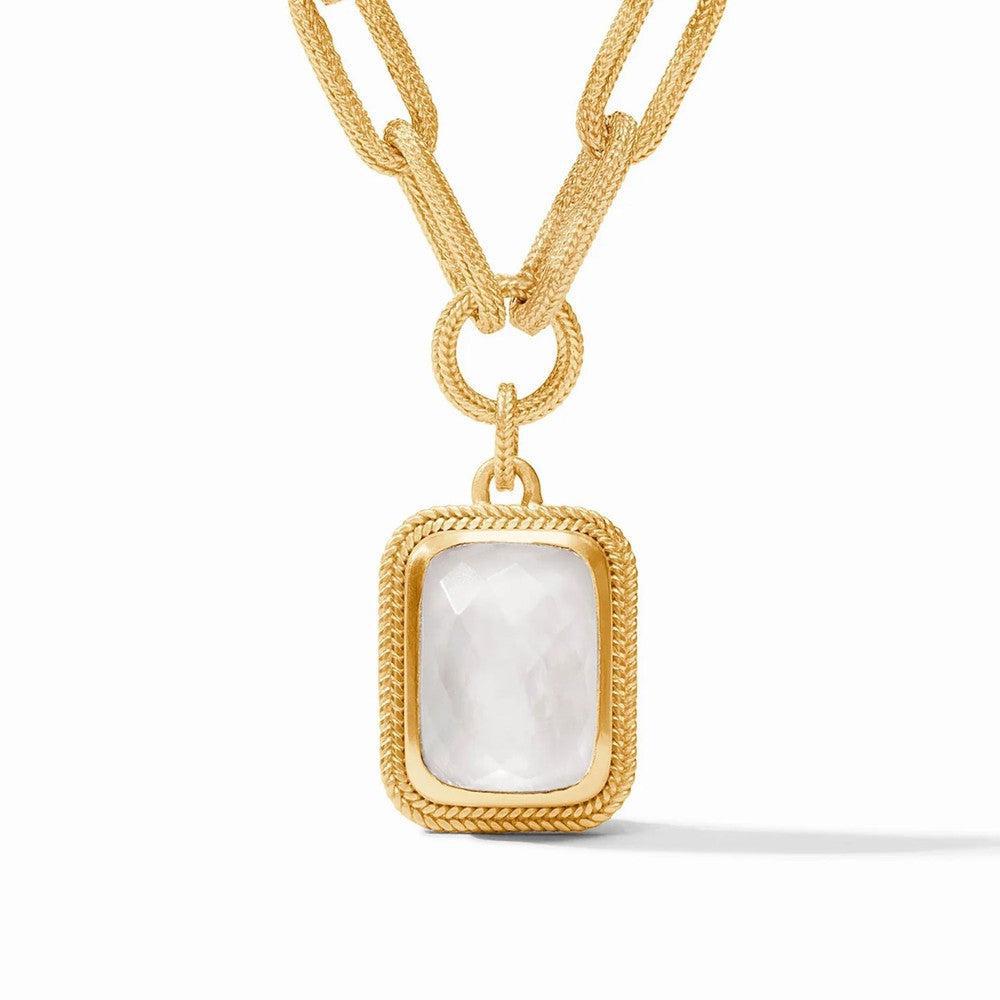 Gold statement necklace featuring a rectangular opal pendant with a textured gold frame.