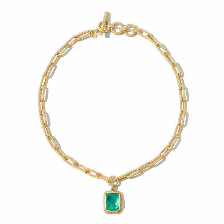 Gold chain necklace with textured links and a green gemstone pendant.