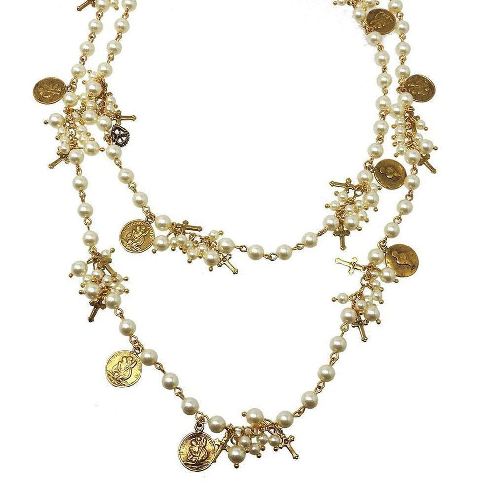 Elegant double-strand pearl necklace adorned with gold crosses and charms.