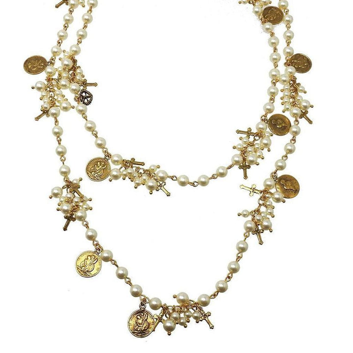 Elegant double-strand pearl necklace adorned with gold crosses and charms.