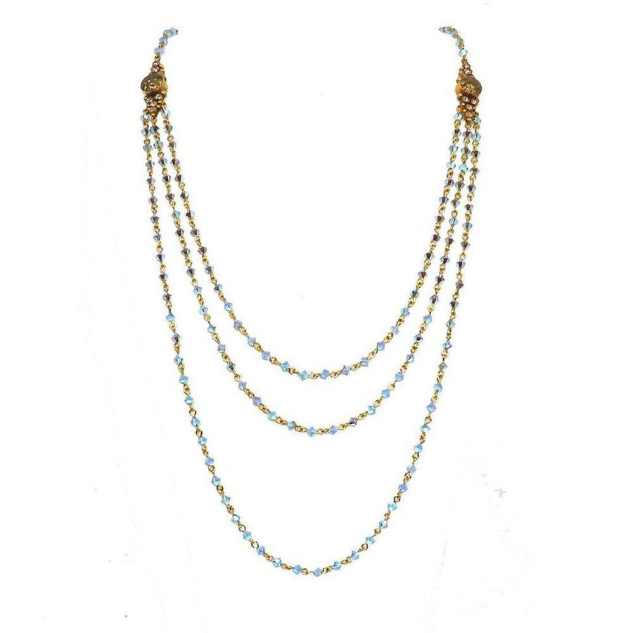 Fay Winged Bicone Magdalena necklace: Three-strand, light blue crystal and gold chain.