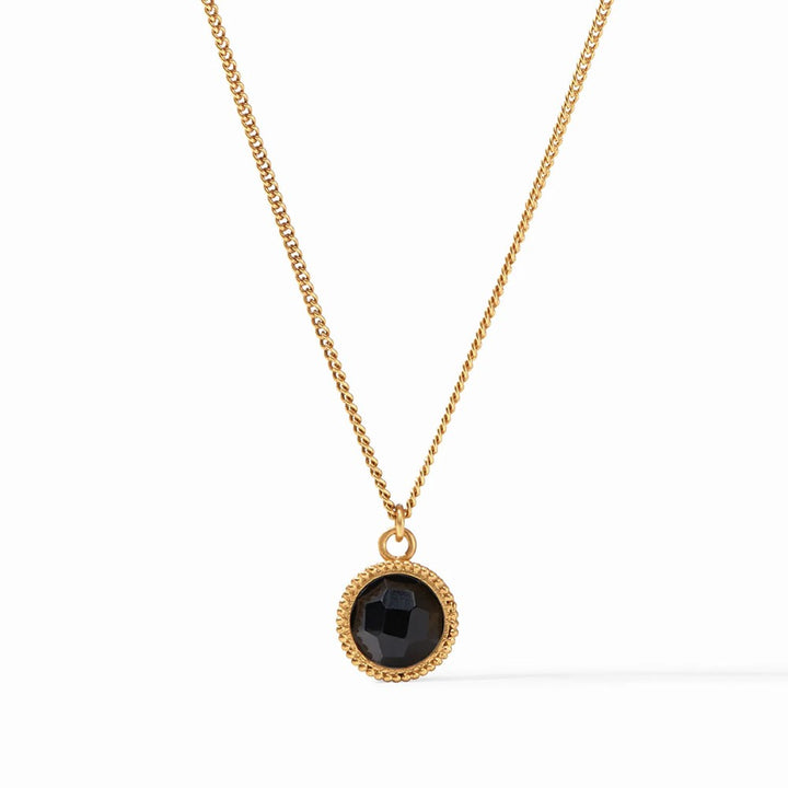 Gold chain necklace with a black gemstone pendant.