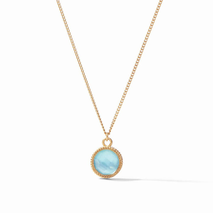 Gold chain necklace with light blue gemstone pendant.