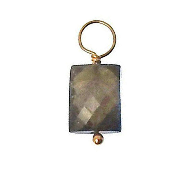 Dark gray gemstone pendant with gold accents; rectangular stone.