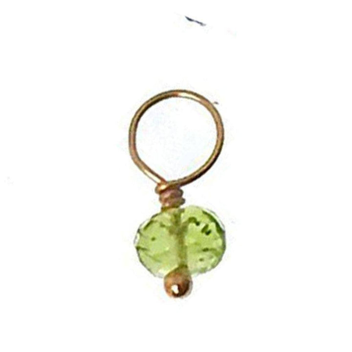 Green gemstone charm with gold wire setting.