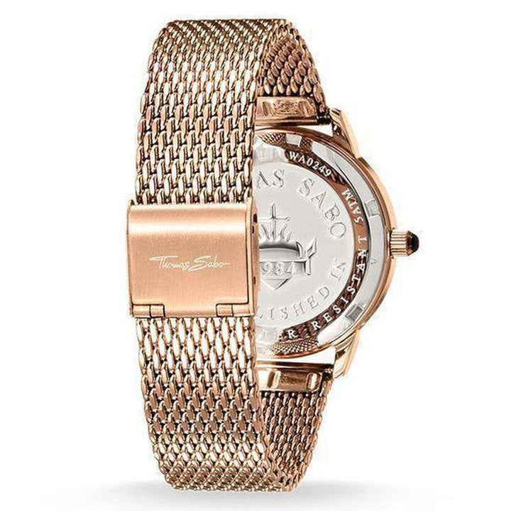Rose gold watch with a mesh band, showcasing a detailed back design.